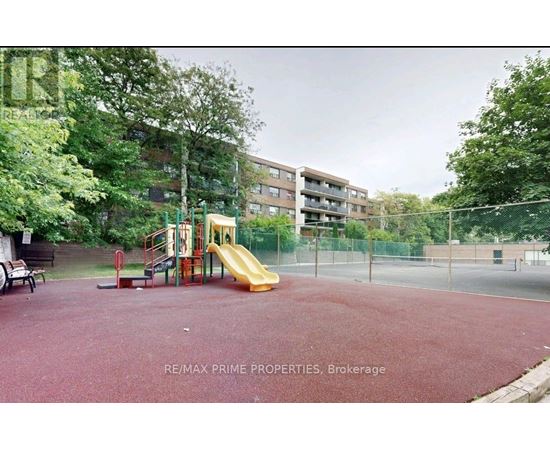 A playground with a slide and a red surface.