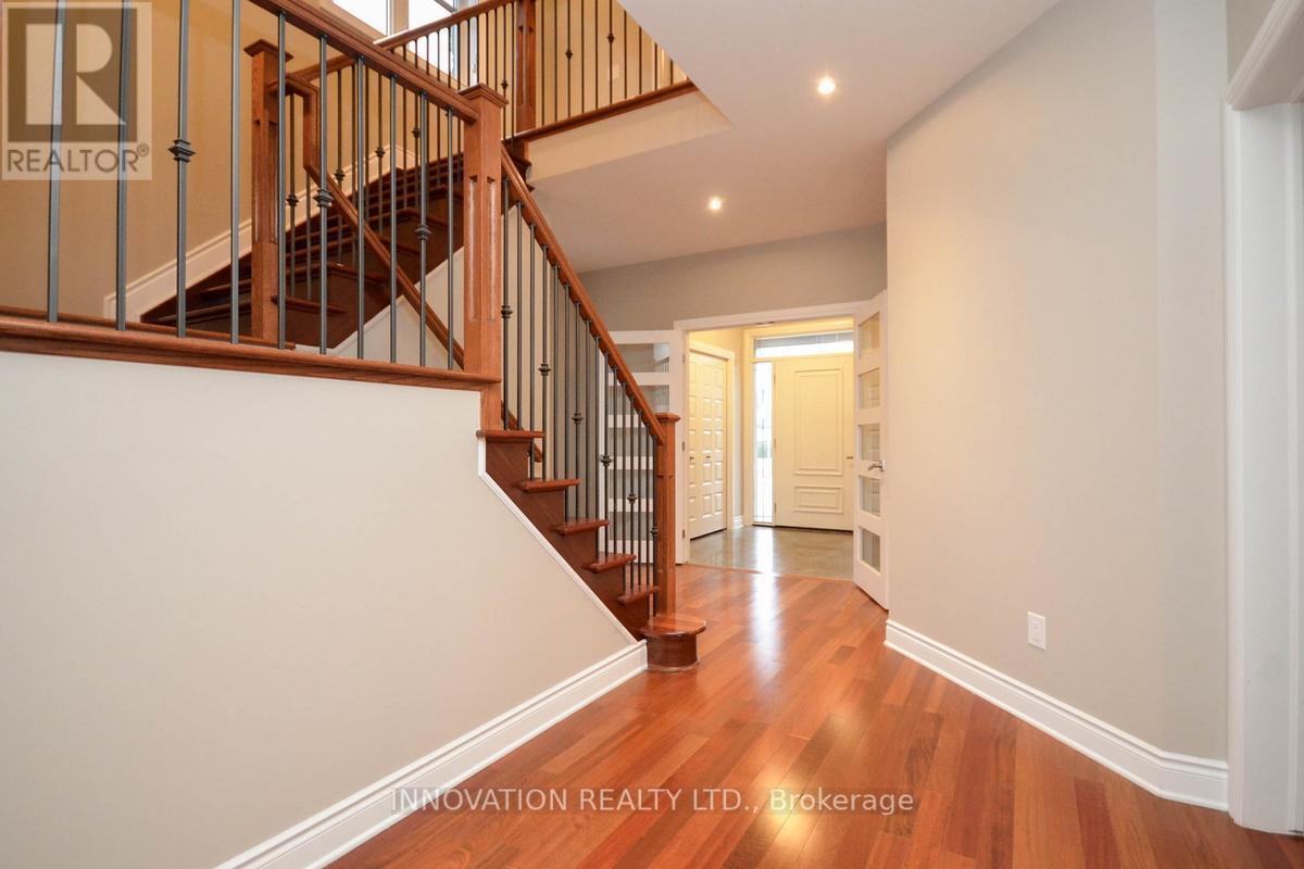 A hallway with a staircase and a doorway.