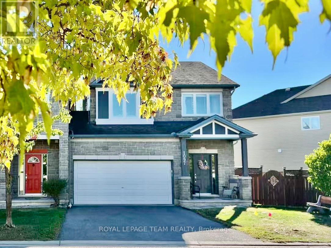 A house with a red door and a white garage door is for sale.