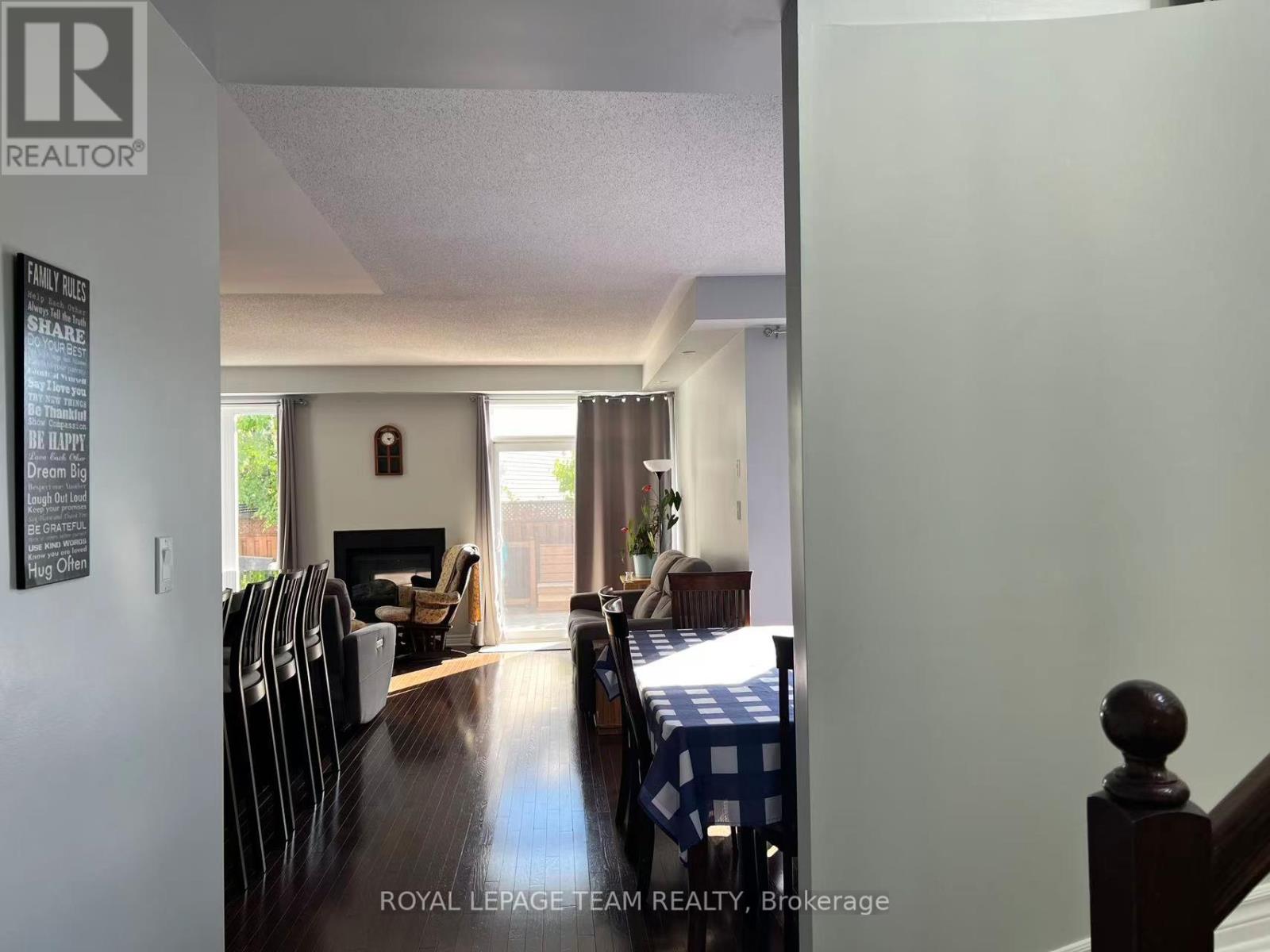 A dining room with a table set for four.