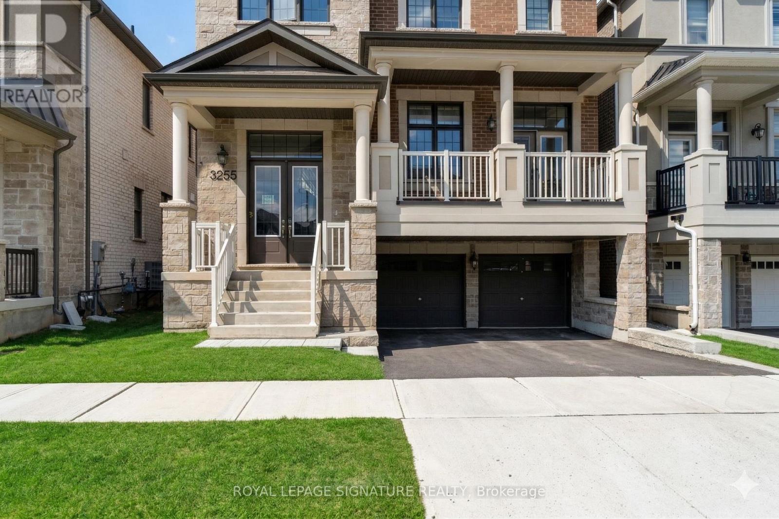 A two-story house with a balcony and a garage.