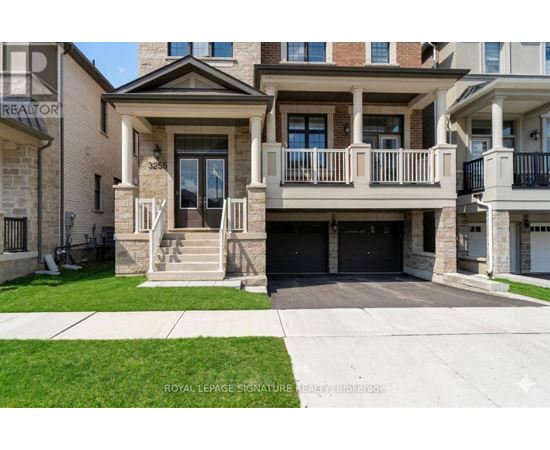 A two-story house with a balcony and a garage.