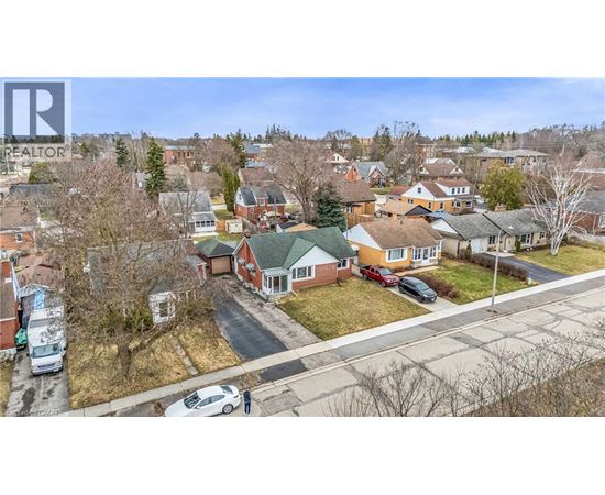 A bird's eye view of a residential neighborhood with houses and parked cars.