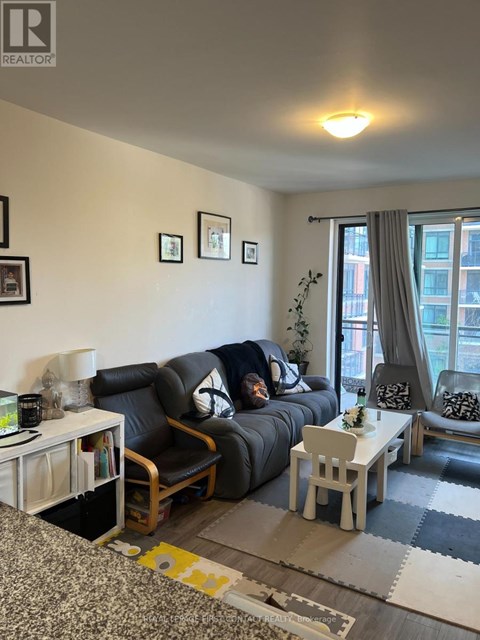 A living room with a grey couch and a white coffee table.