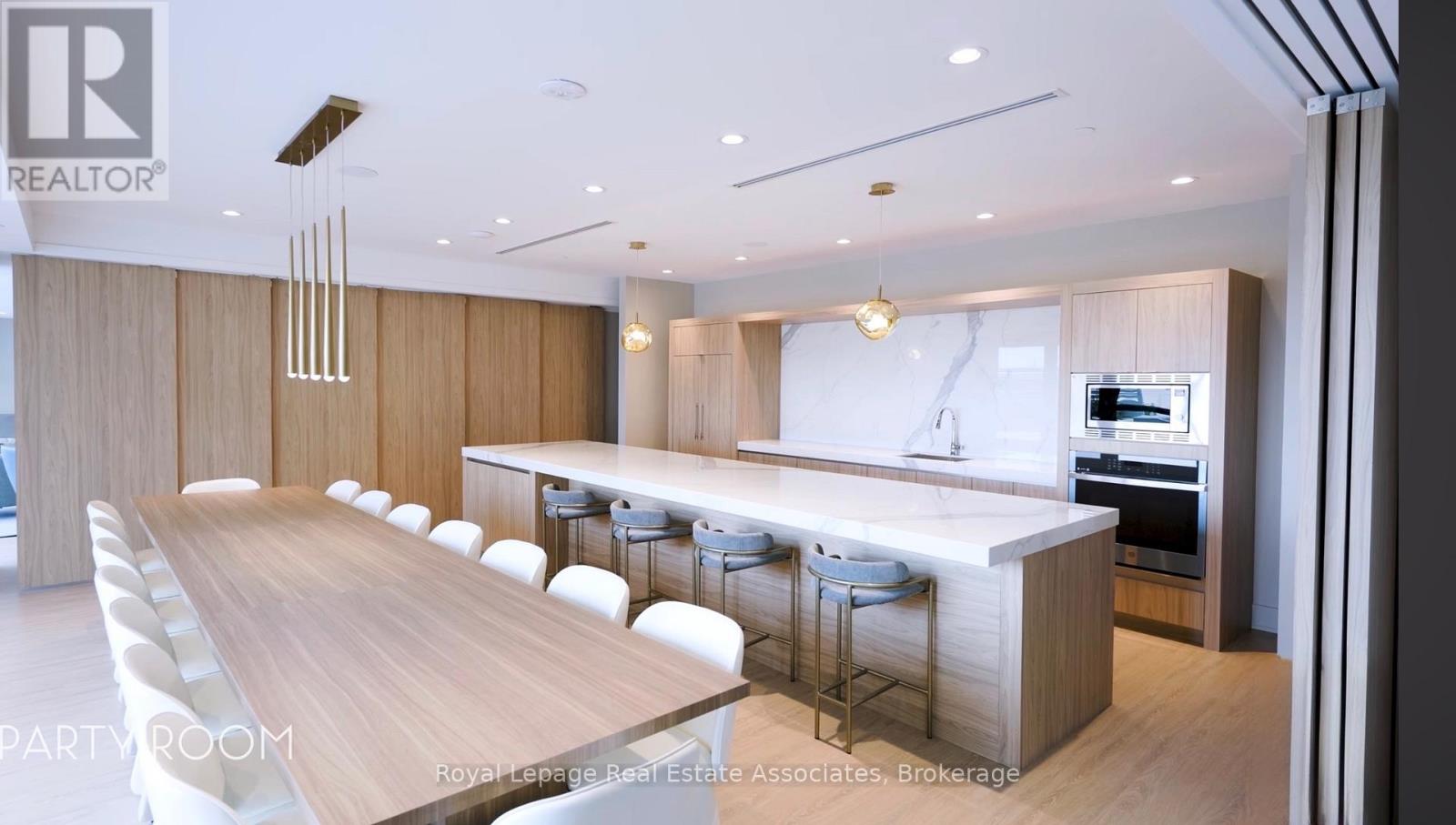 A modern dining room with a long table and chairs.