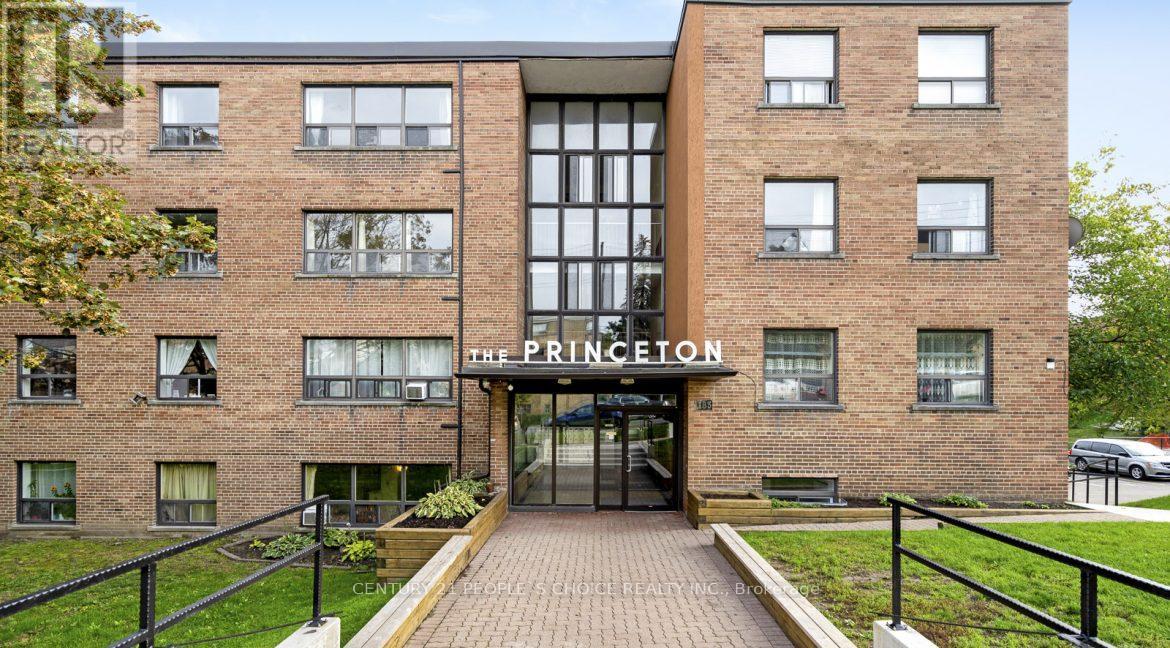 The Princeton apartment building has a black railing in front.