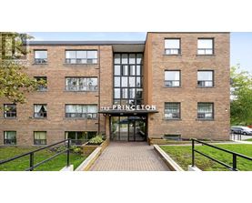 The Princeton apartment building has a black railing in front.