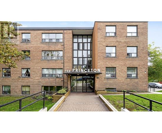 The Princeton apartment building has a black railing in front.