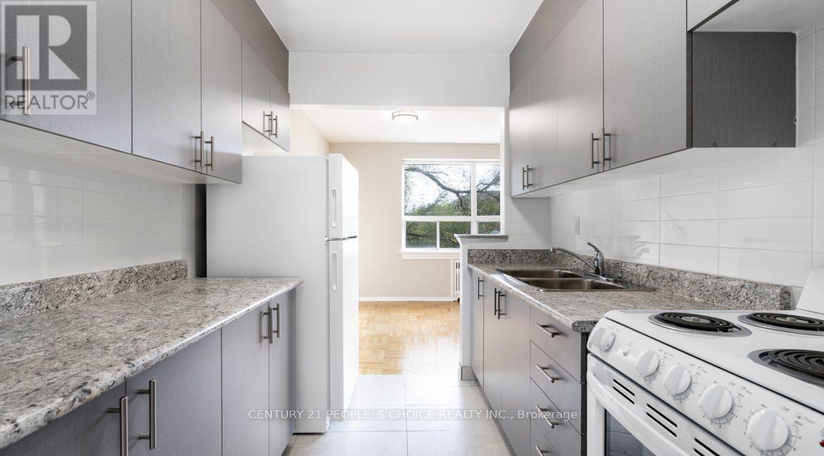 A kitchen with granite countertops and white cabinets.