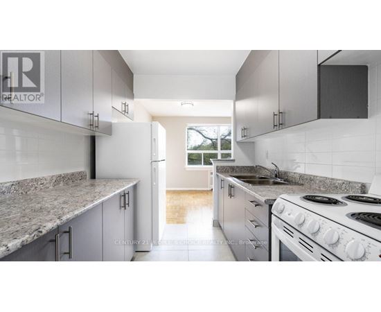 A kitchen with granite countertops and white cabinets.