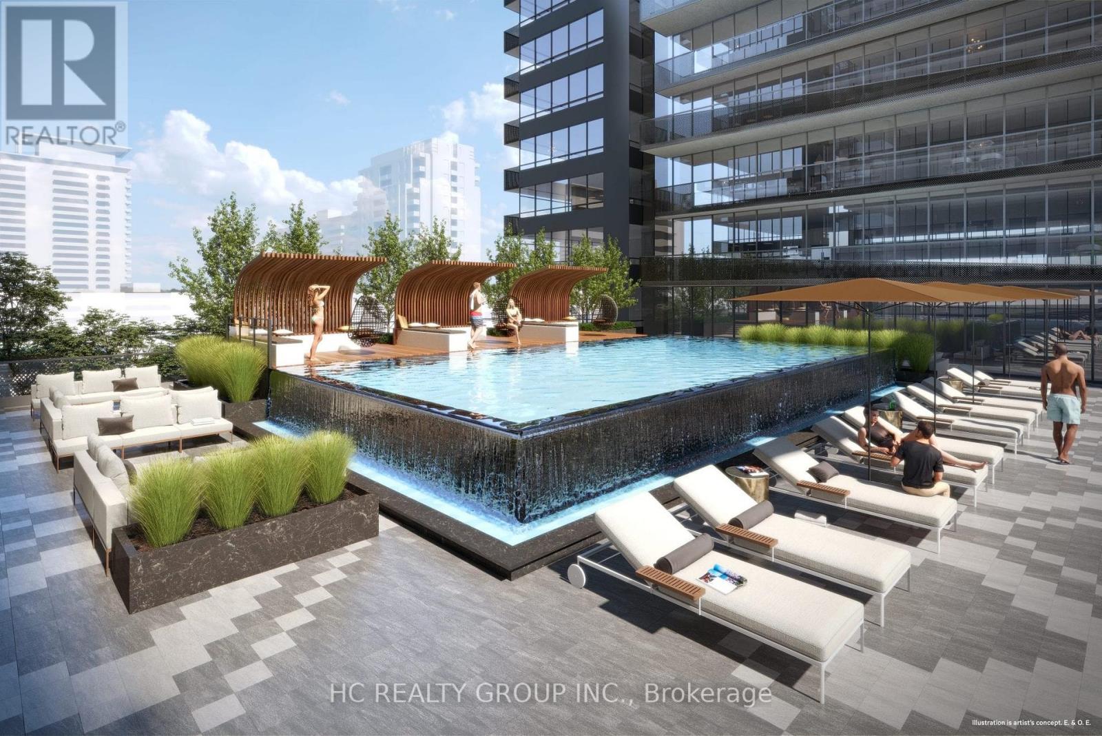 A pool area with sun loungers and a waterfall feature.