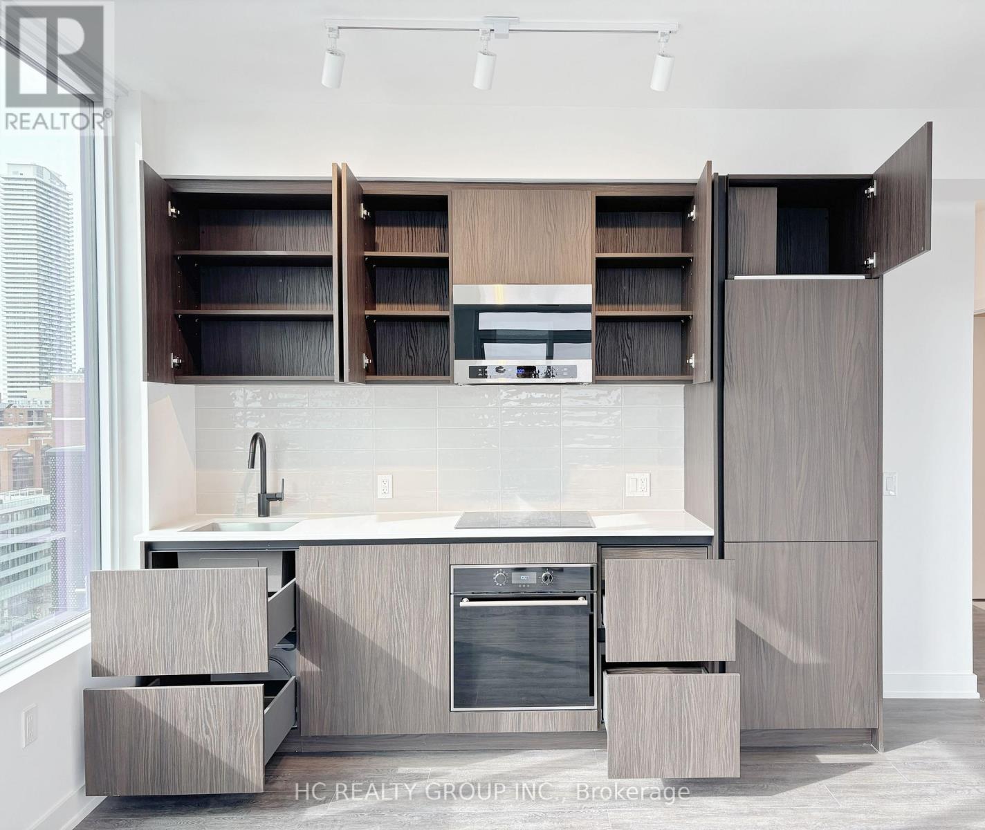 A modern kitchen with a large island and wooden cabinets.