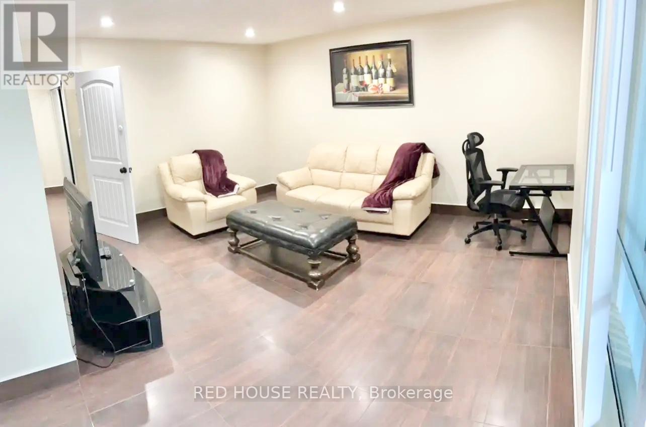 A living room with a couch, chair, and television.