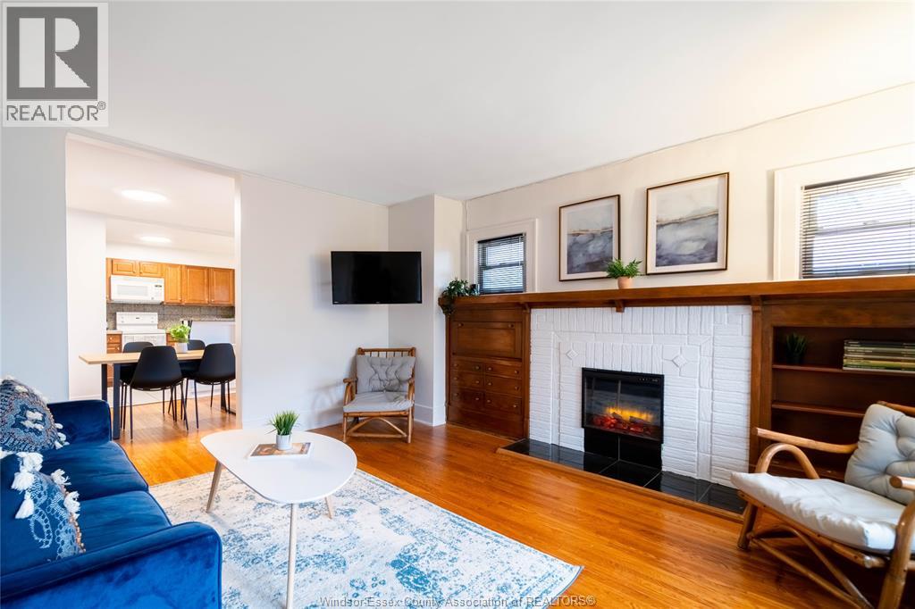 A living room with a fireplace and a blue couch.