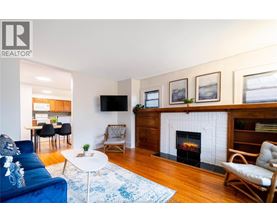 A living room with a fireplace and a blue couch.