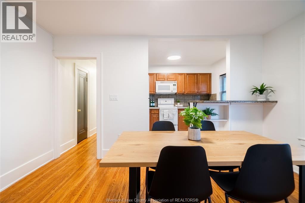A dining room with a wooden table and chairs.