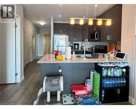 A kitchen with a counter and a chair.