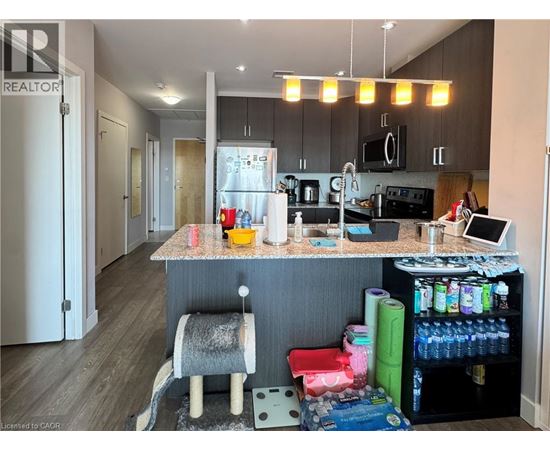 A kitchen with a counter and a chair.