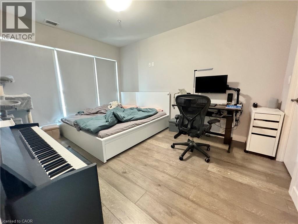 A bedroom with a bed, desk, and chair.