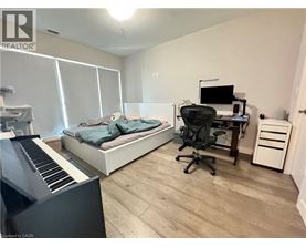 A bedroom with a bed, desk, and chair.