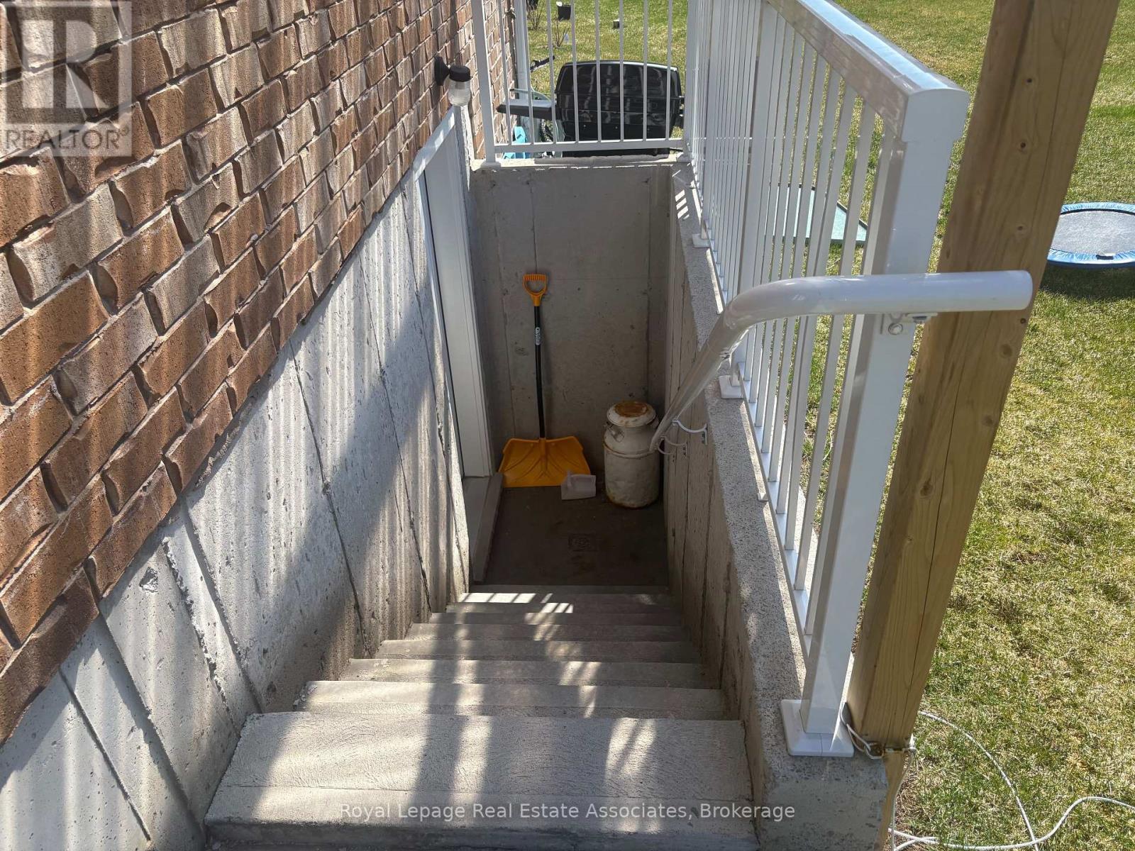A small white step ladder is leaning against a white railing.