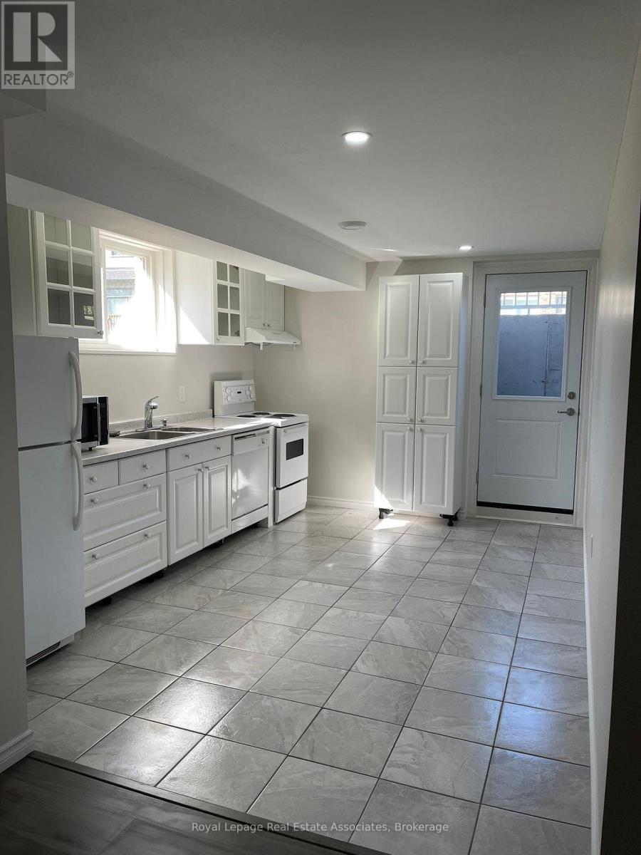 A kitchen with white appliances and cabinets.
