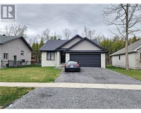 A house with a grey roof and a car parked in front.