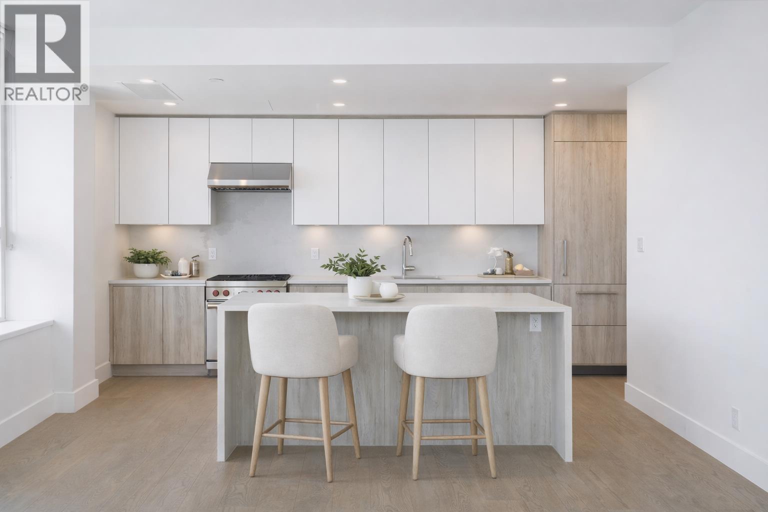 A modern kitchen with white cabinets and a center island.