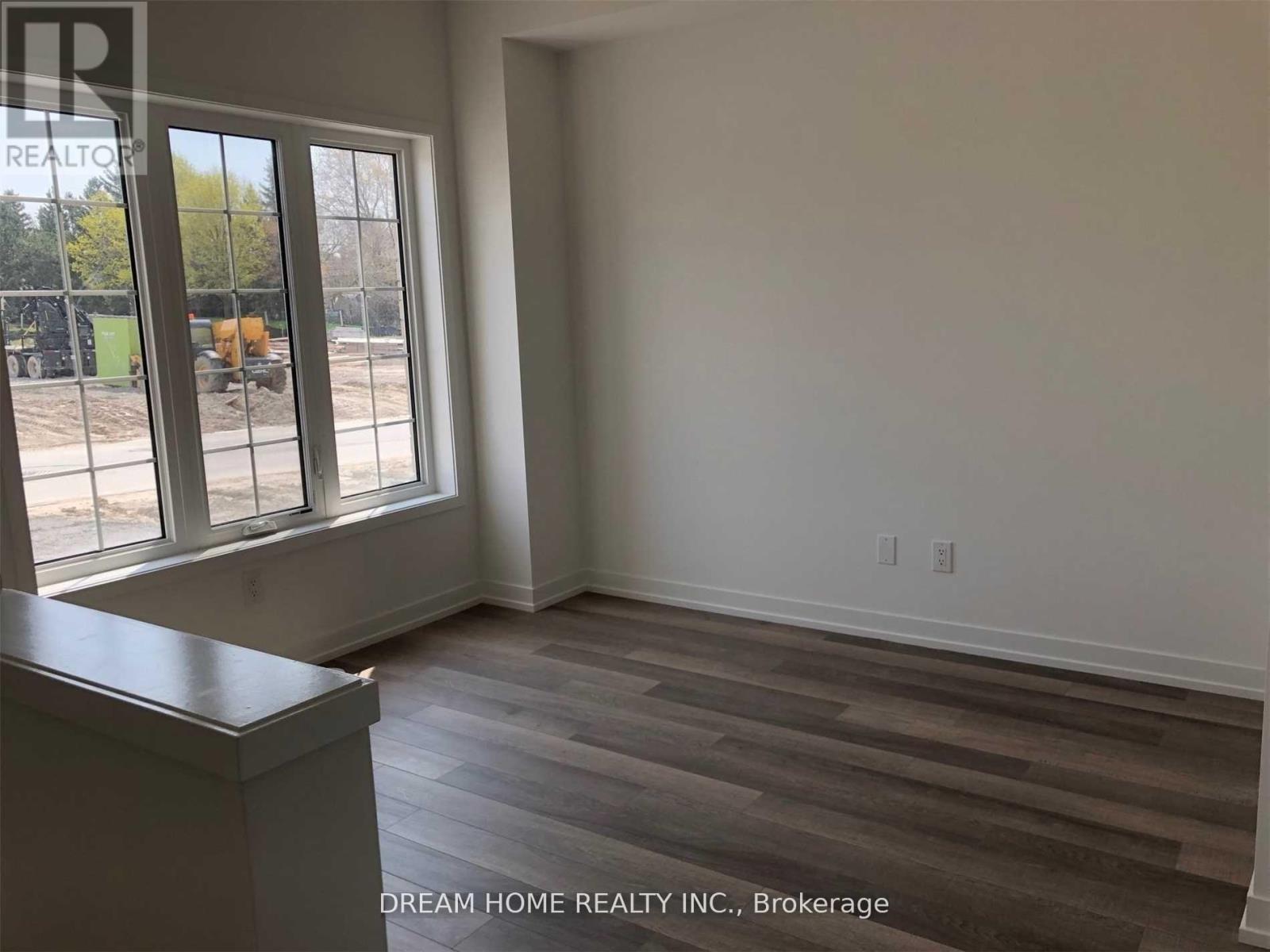 A room with a window overlooking a construction site.