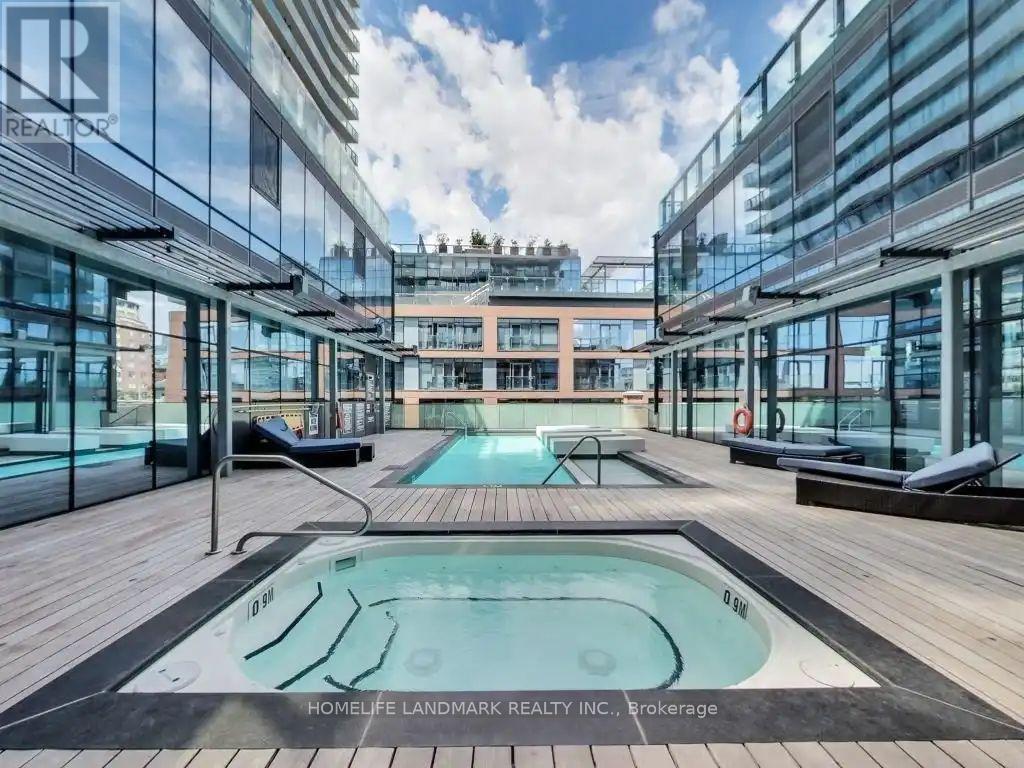 A pool in the middle of a glass-walled building.