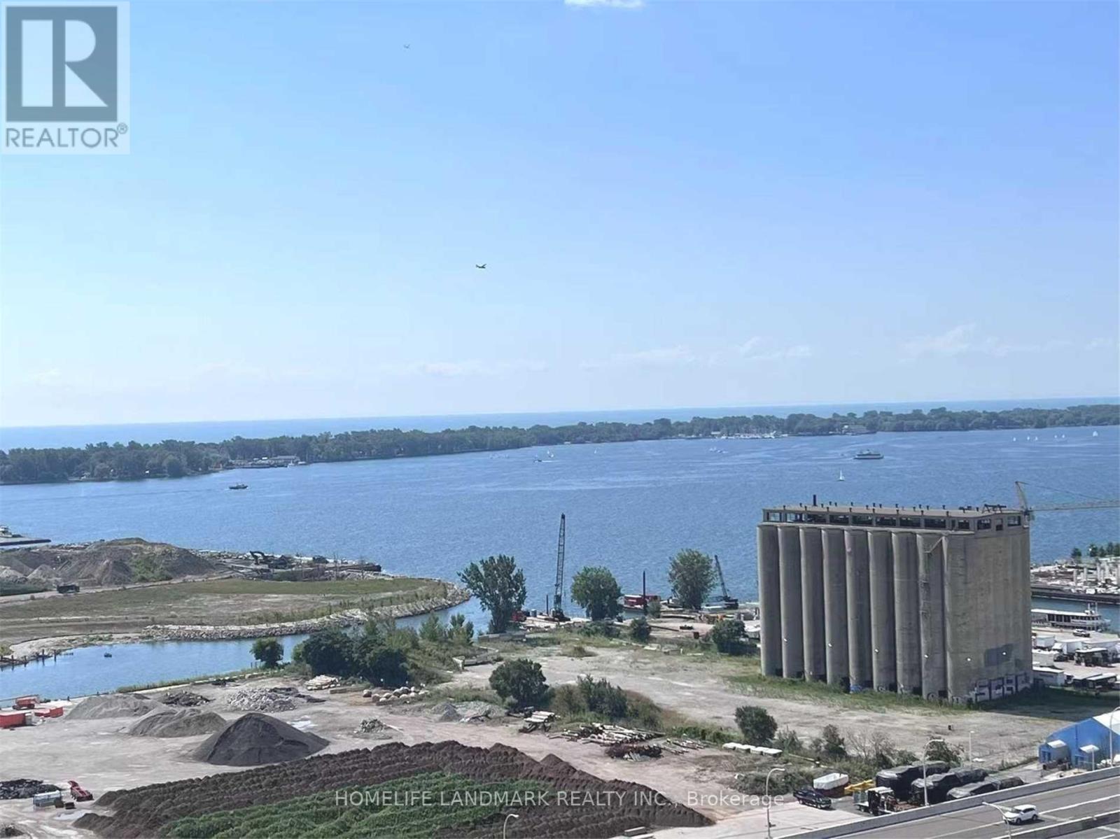 A construction site with a large body of water in the background.