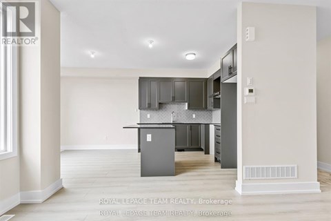 A modern kitchen with a dining table and chairs.