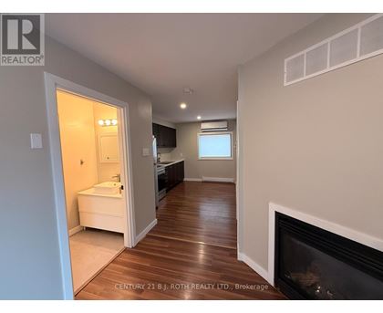 A bathroom with a fireplace and a window.