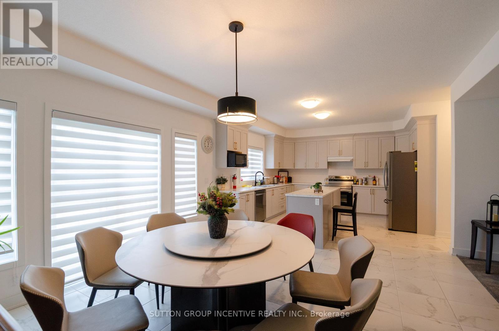 A modern kitchen with a dining table and chairs.