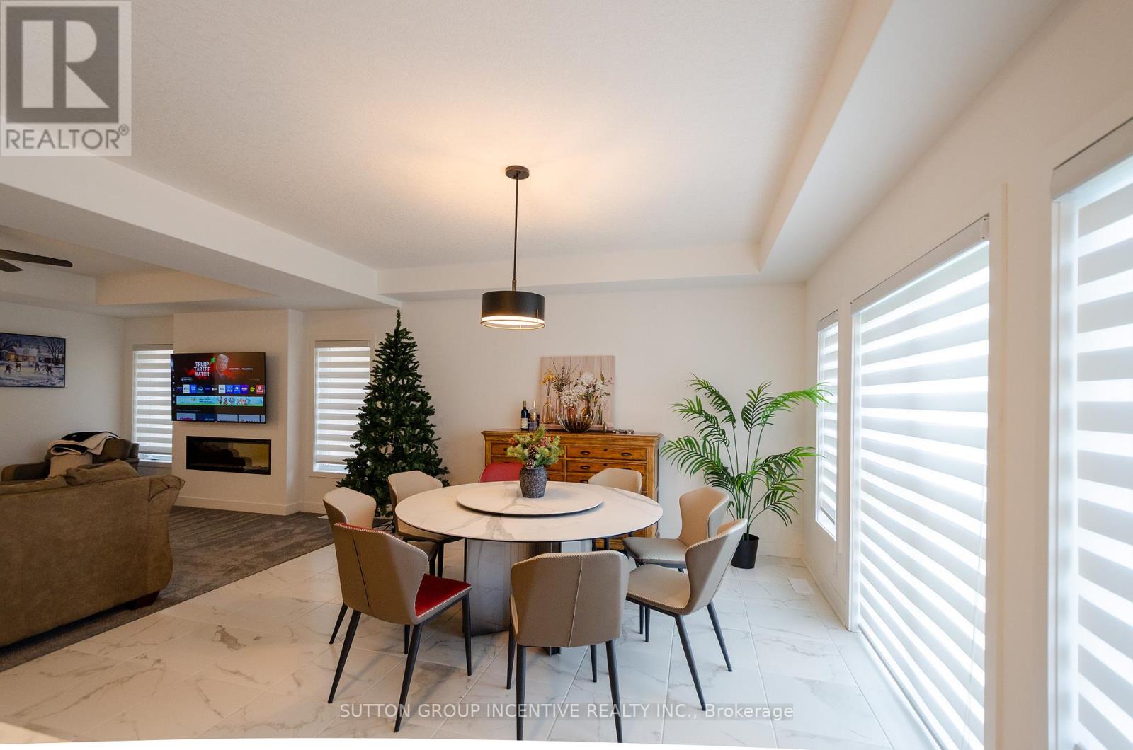 A dining room with a white table and chairs.