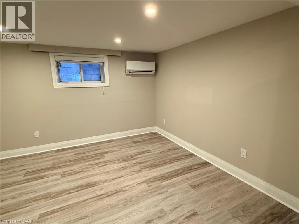 A room with a window and a wall-mounted air conditioner.