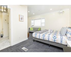 A bedroom with a bed and a couch in it.