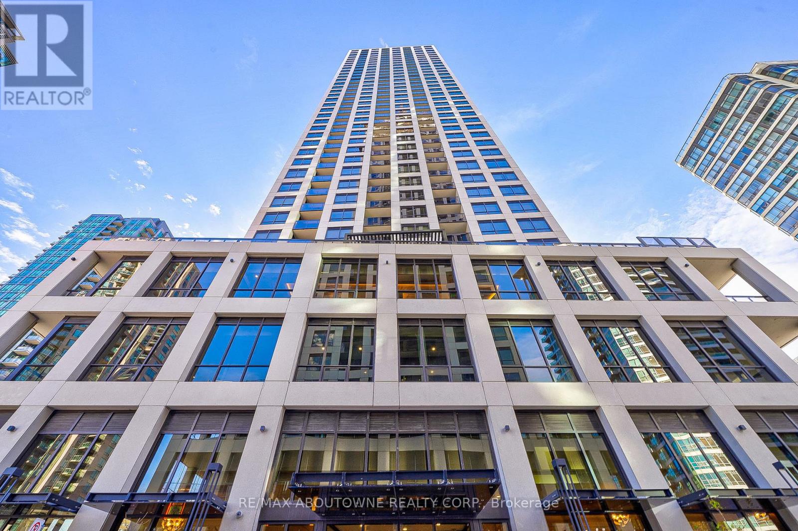 A tall building with a sign that reads "RE/MAX ADUTOWNE REALTY CORP. Brokerage".