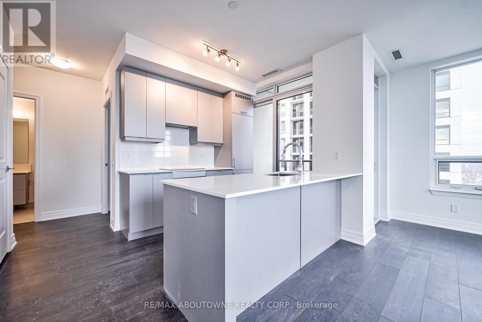 A spacious kitchen with white cabinets and a large island.
