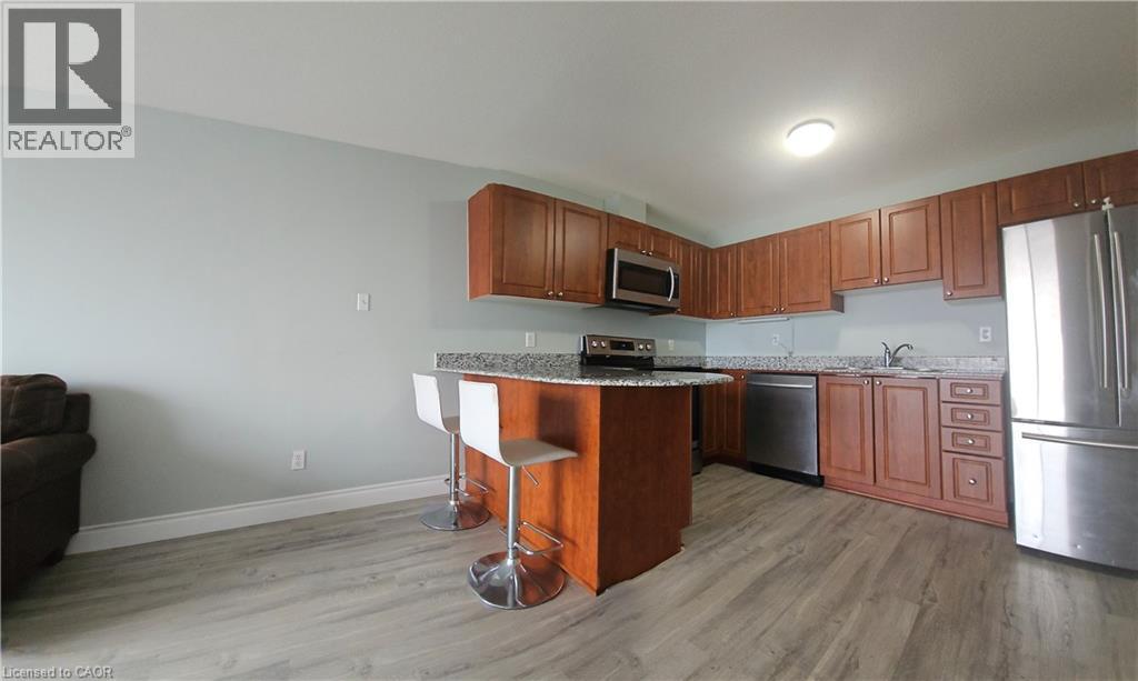 A kitchen with wooden cabinets and a granite countertop.