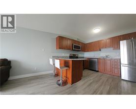 A kitchen with wooden cabinets and a granite countertop.