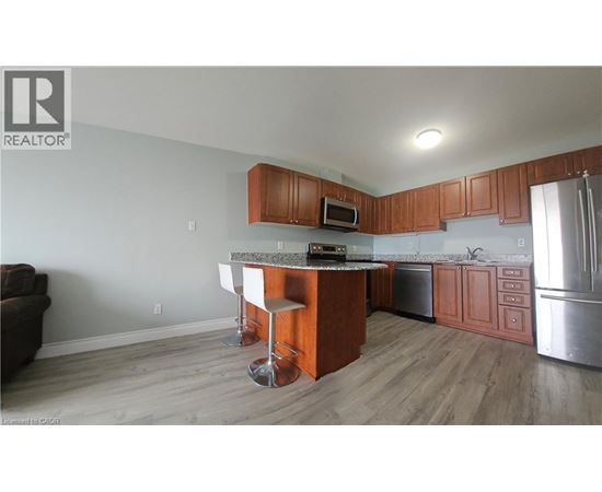 A kitchen with wooden cabinets and a granite countertop.