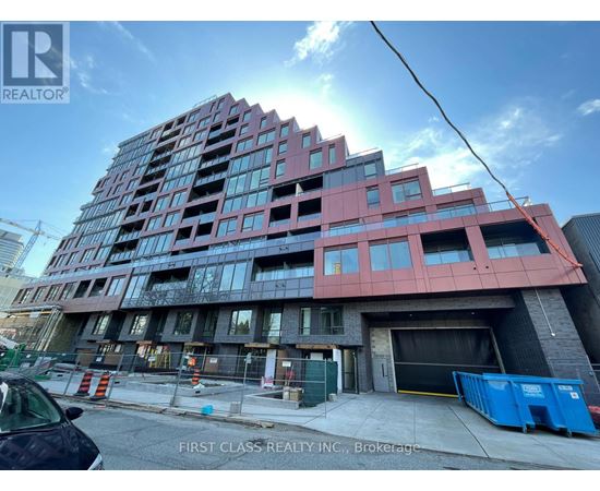 A building under construction with a sign that says "First Class Realty Inc., Brokerage".