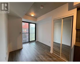 A room with a sliding glass door leading to a balcony.