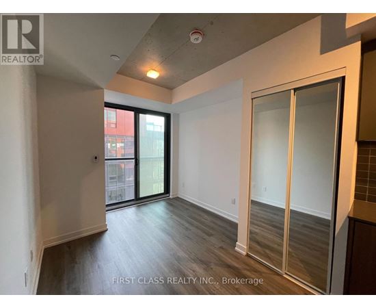 A room with a sliding glass door leading to a balcony.