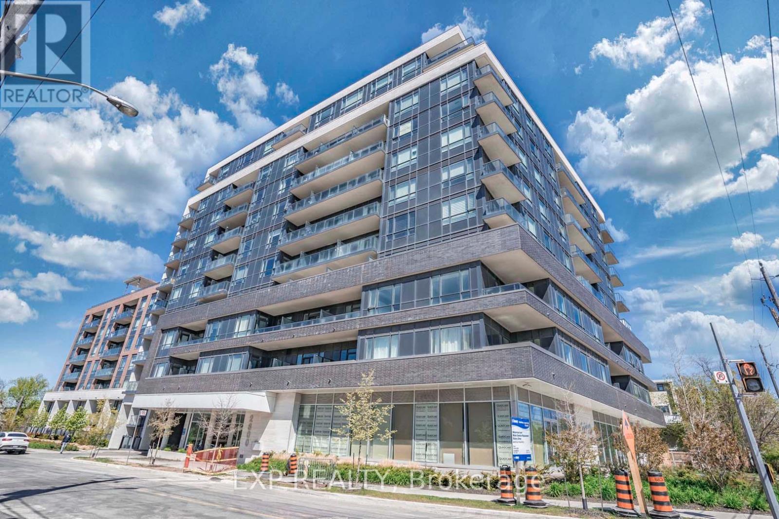 A modern multi-story building with a glass facade and a sign that reads "Crooked Edge.".
