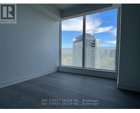 A room with a large window overlooking a cityscape.