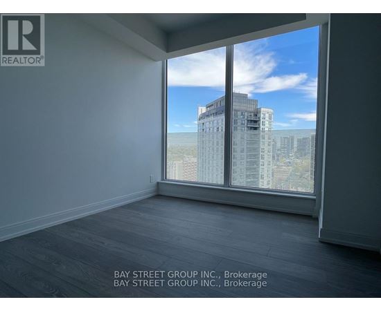A room with a large window overlooking a cityscape.