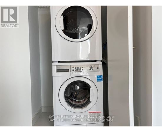 A white washing machine with the door open is in a room.