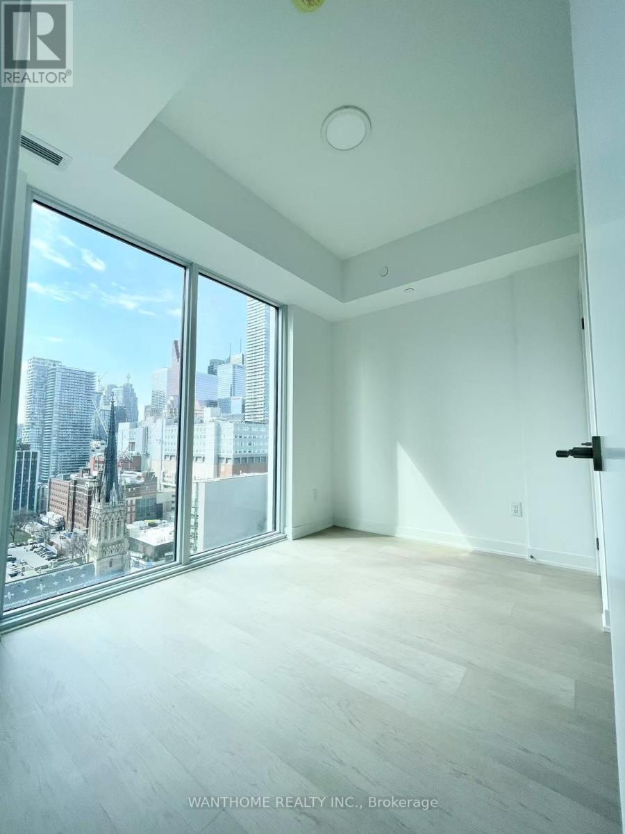 A spacious room with a view of the cityscape outside the large window.